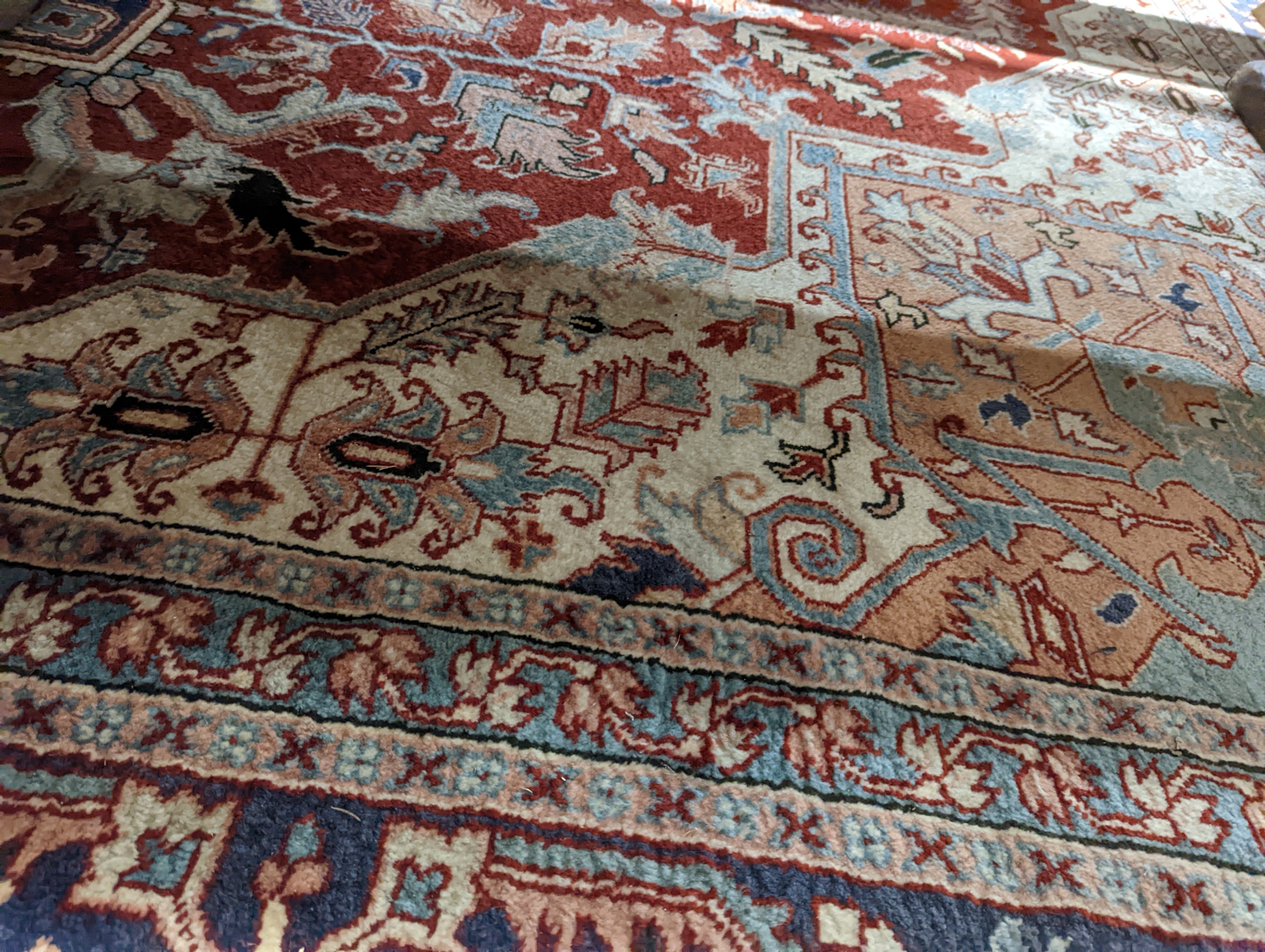 A large Caucasian style red ground carpet, 460 x 330cm